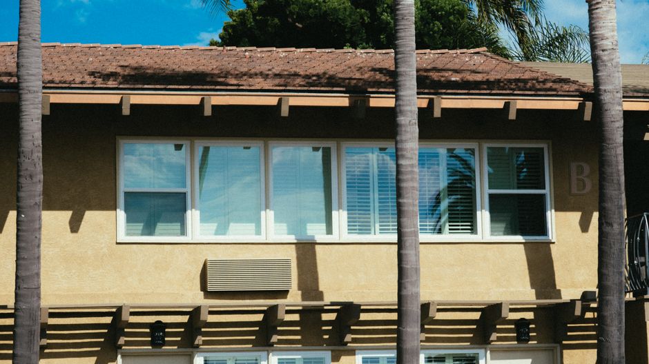 A modern house facade with a row of windows.